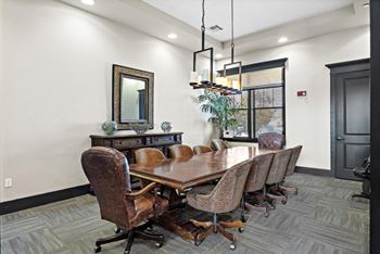 A conference room with a large table and chairs